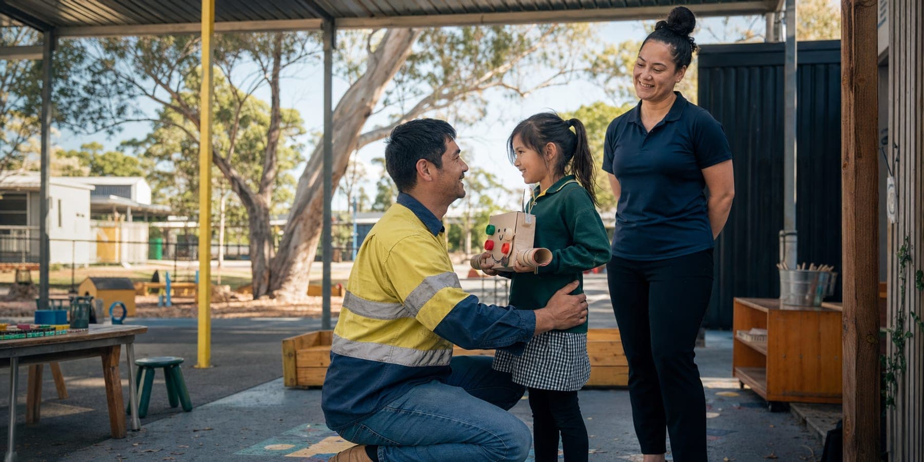 An OSHC educator supervises as a child reunites with her father at an Australian school.